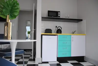 a kitchen with a counter and a table with a sink at HP Twelve Accommodation in Nelspruit