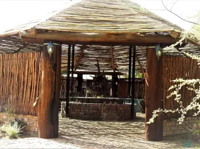 a wooden pavilion with a roof on a patio at Witgatboom Boskamp in Naboomspruit
