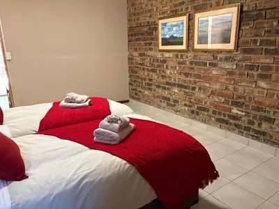 a bedroom with a bed with towels on it at Witgatboom Boskamp in Naboomspruit