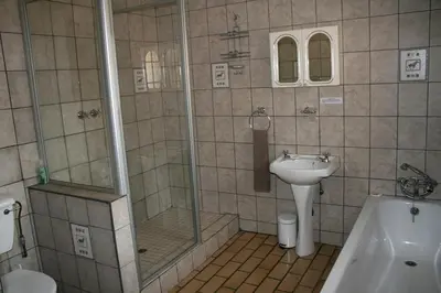 a bathroom with a shower and a sink at Tamboti House in Malelane