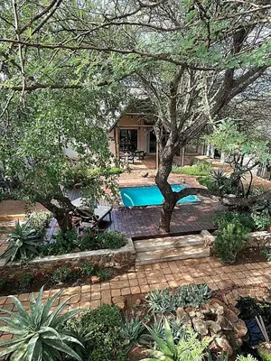 a house with a swimming pool in a yard at Switsongo B&B in Hoedspruit