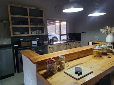 a kitchen with a wooden counter top in a kitchen at Switsongo B&B in Hoedspruit