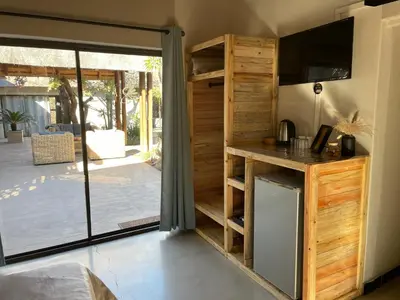 a kitchen with a sliding glass door leading to a patio at Switsongo B&B in Hoedspruit