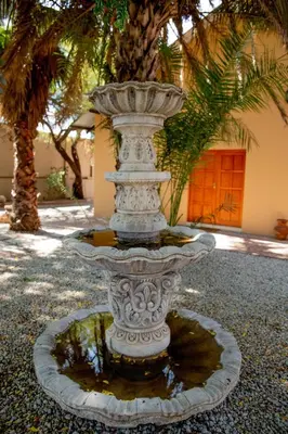 a large stone fountain in front of a building at Tambati Overnight and Conference Center in Polokwane