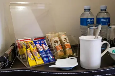 a table with a cup of coffee and some snacks at Tambati Overnight and Conference Center in Polokwane