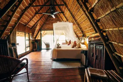 a bedroom in a tree house with a bed in it at Pezulu Tree House Lodge in Hoedspruit