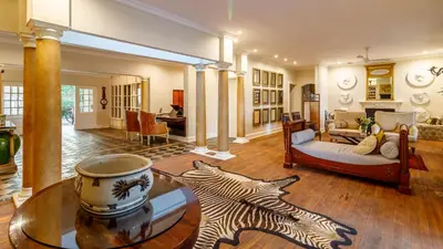 a living room with a zebra rug on the floor at Serra Azul Lodge in Hazyview