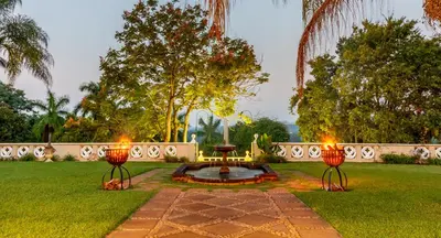 a garden with two lights in the grass at Serra Azul Lodge in Hazyview