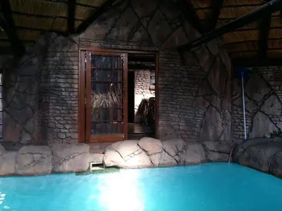 a house with a large swimming pool with a door at Pride Rock Accommodation in Middelburg