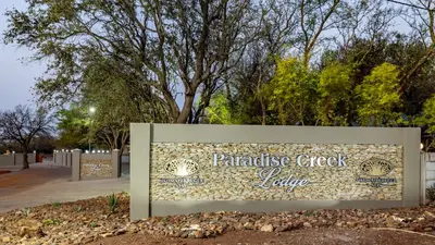 a sign for the parkridge creek lodge at Paradise Creek Lodge in Malelane