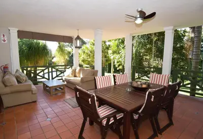 a living room with a wooden table and chairs at Cuckoos Nest Guest House in Louis Trichardt