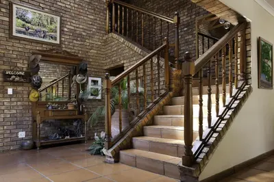 a staircase in a house with a brick wall at Peter's Guesthouse in Pretoria