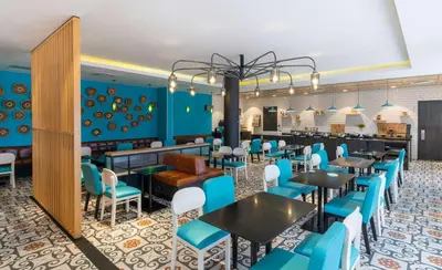 a dining room with blue chairs and tables at Park Inn by Radisson Polokwane in Polokwane