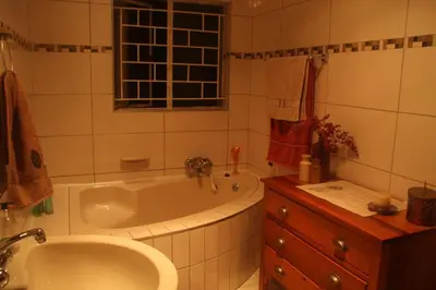 a bathroom with a tub and a sink at 800@Merton in Pretoria