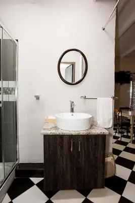 a bathroom with a sink and a mirror on the wall at Windmills Rest in Pretoria