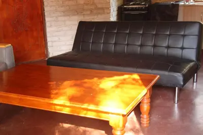 a leather couch and a coffee table in a living room at Roundhouse Marloth Park in Marloth Park