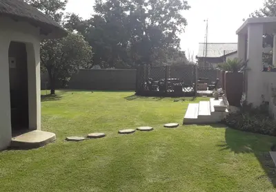 a yard with stepping stones in the grass at Lallapanzi Country Stay in Ermelo