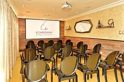 a conference room with chairs in front of a screen at Kgarebana Boutique Guesthouse in Tweefontein