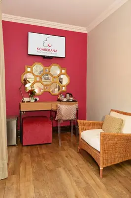 a room with a table and a red wall at Kgarebana Boutique Guesthouse in Tweefontein