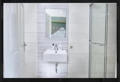 a white bathroom with a sink and a shower at Oleratong Guest House in Evander