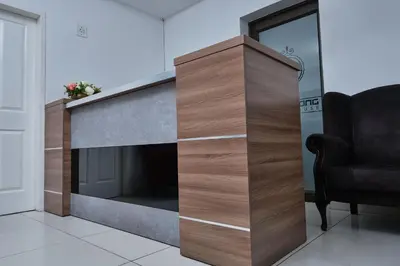 a fireplace in a living room with a chair at Oleratong Guest House in Evander