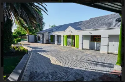 a house with a brick driveway in front of it at Oleratong Guest House in Evander