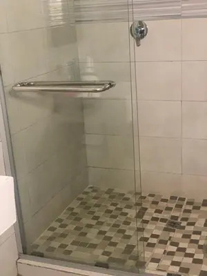 a shower with a glass door in a bathroom at Oleratong Guest House in Evander