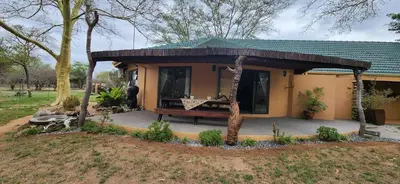 a small house with a bench in front of it at Motlala Game Lodge in Hoedspruit