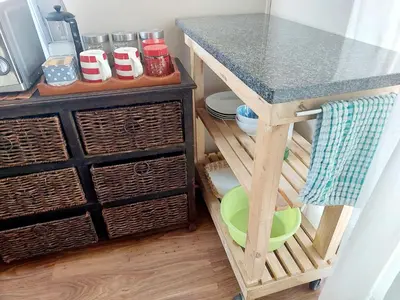 a kitchen island with a counter top and baskets at Adorable Designs in Pretoria