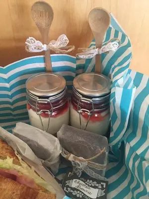 two jars of food with spoons and a sandwich at White Linen Guesthouse in Tierpoort
