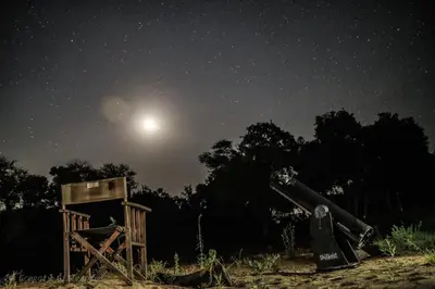 a full moon shines over an abandoned observatory at night at Rhino Post Safari Lodge in Skukuza