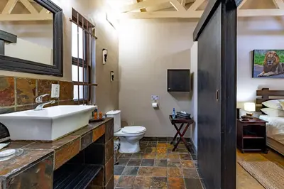 a bathroom with a tub and a toilet and a sink at Dreamfields Guesthouse in Hazyview