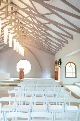 a room with white chairs and a ceiling with chandeliers at Oxbow Country Estate in Erasmus