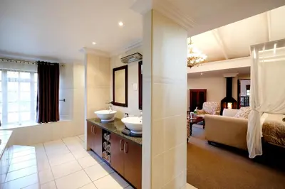 a bathroom with two sinks and a living room at Oxbow Country Estate in Erasmus