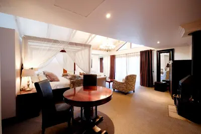 a hotel room with a bed and a table at Oxbow Country Estate in Erasmus