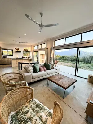 a living room with a couch and a table at 24 Degrees South Country Estate in Hoedspruit