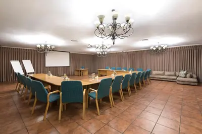 a conference room with a long table and chairs at Our Heritage Guesthouse in Kempton Park