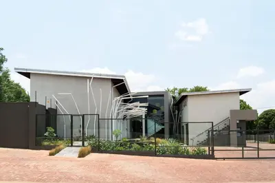 a building with a fence in front of it at Alpine Attitude Boutique Hotel & Conference Venue in Pretoria