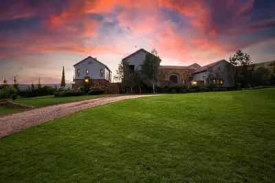 a house on a hill with a green lawn at Mount High Luxury Country Estate in Lydenburg