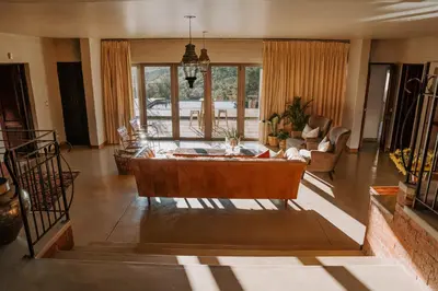 a living room with a couch and a table at Mount High Luxury Country Estate in Lydenburg