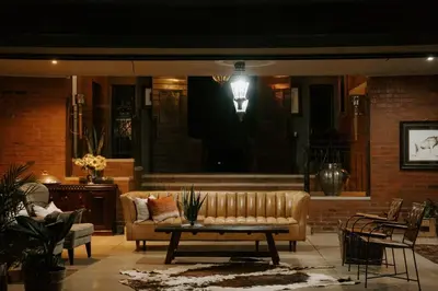 a living room with a couch and a table at Mount High Luxury Country Estate in Lydenburg