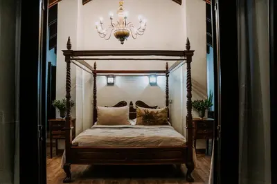 a bedroom with a canopy bed with a chandelier at Mount High Luxury Country Estate in Lydenburg
