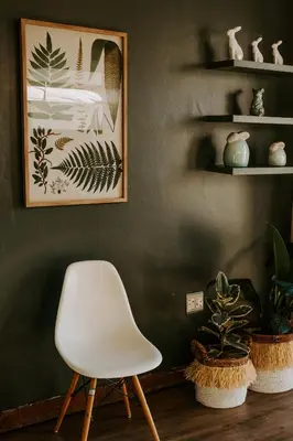 a white chair in a room with plants at Mount High Luxury Country Estate in Lydenburg