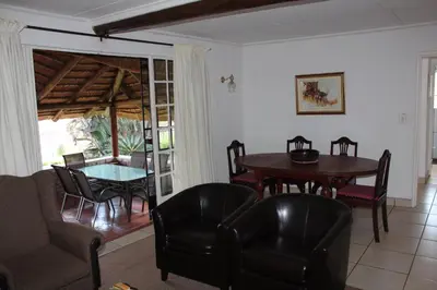 a living room with a table and chairs at Klipkopje Guest Cottage in White River