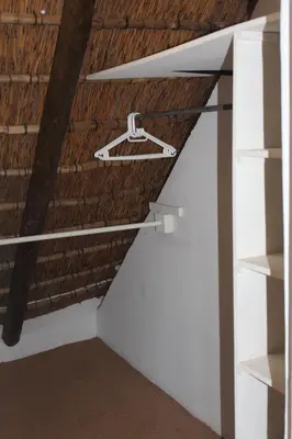 a closet in a room with a brick wall at Klipkopje Guest Cottage in White River