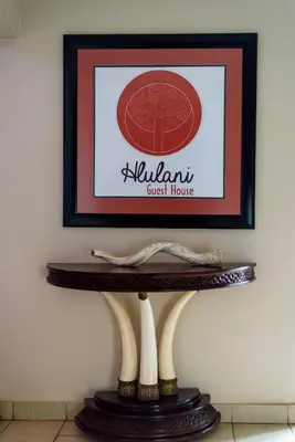 a table with a picture of a korean guest house at Hlulani Guest House in Northam