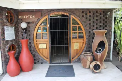 a group of vases sitting in front of a building at Royal Game Guest House in Phalaborwa
