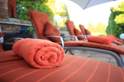 a red teddy bear laying on top of a table at Schneiders Boutique Hotel in White River