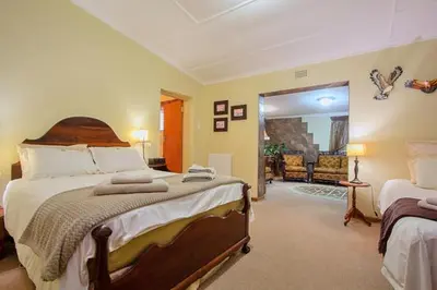 a bedroom with a large bed and a living room at Waterfront Guest House in Carolina