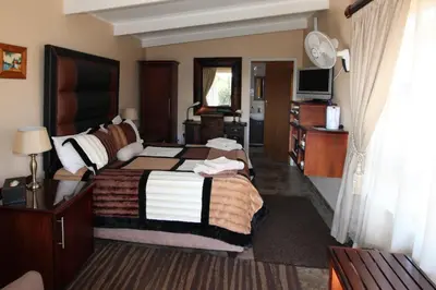 a hotel room with a bed and a television at Waterfront Guest House in Carolina